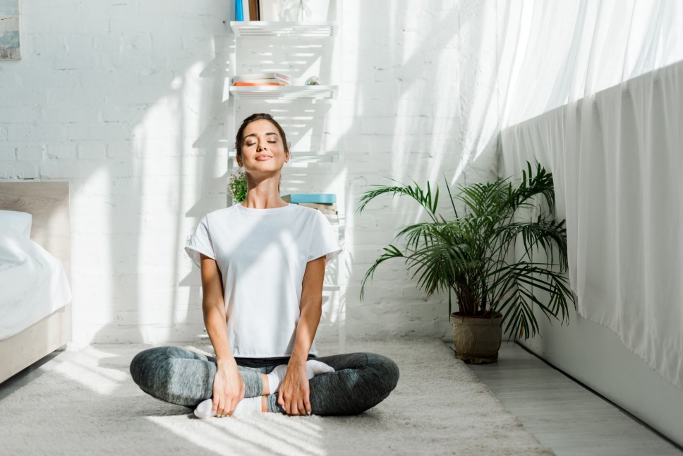 A woman doing yoga in a room with noise-reducing windows